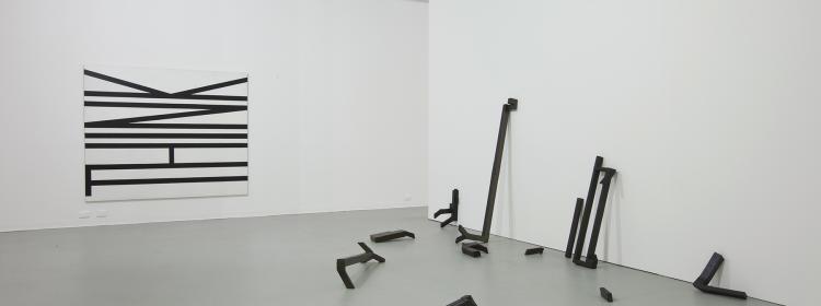 ‘Work for Now’, 2010. Installation view, Australian Experimental Art Foundation, Adelaide, with left: untitled (think), 1990. Enamel panels, each 90 x 210cm; right: the lost routes to lovely, 2001. Oil, gesso, glue, tape, cardboard, dimensions variable.
