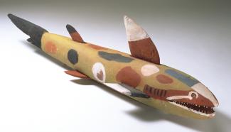 Unknown Artist/s (Aurukun), Freshwater shark, c.1962. Ochres on wood with bone and glass. 20.5 x 133 x 19cm. Collection National Museum of Australia. Frederick McCarthy Collection. Photography George Serras. Courtesy National Museum of Australia.
