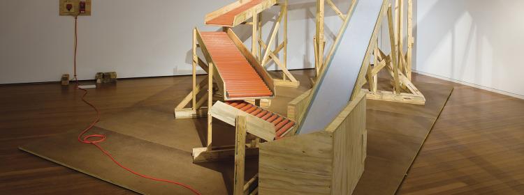 Big One Liner, 2008. Wood, ply, plastic, conveyor belt, electrics, bricks, 300 x 450 x 230cm. Installation view Roslyn Oxley9, Sydney. Photograph: Moshe Rosenberg.